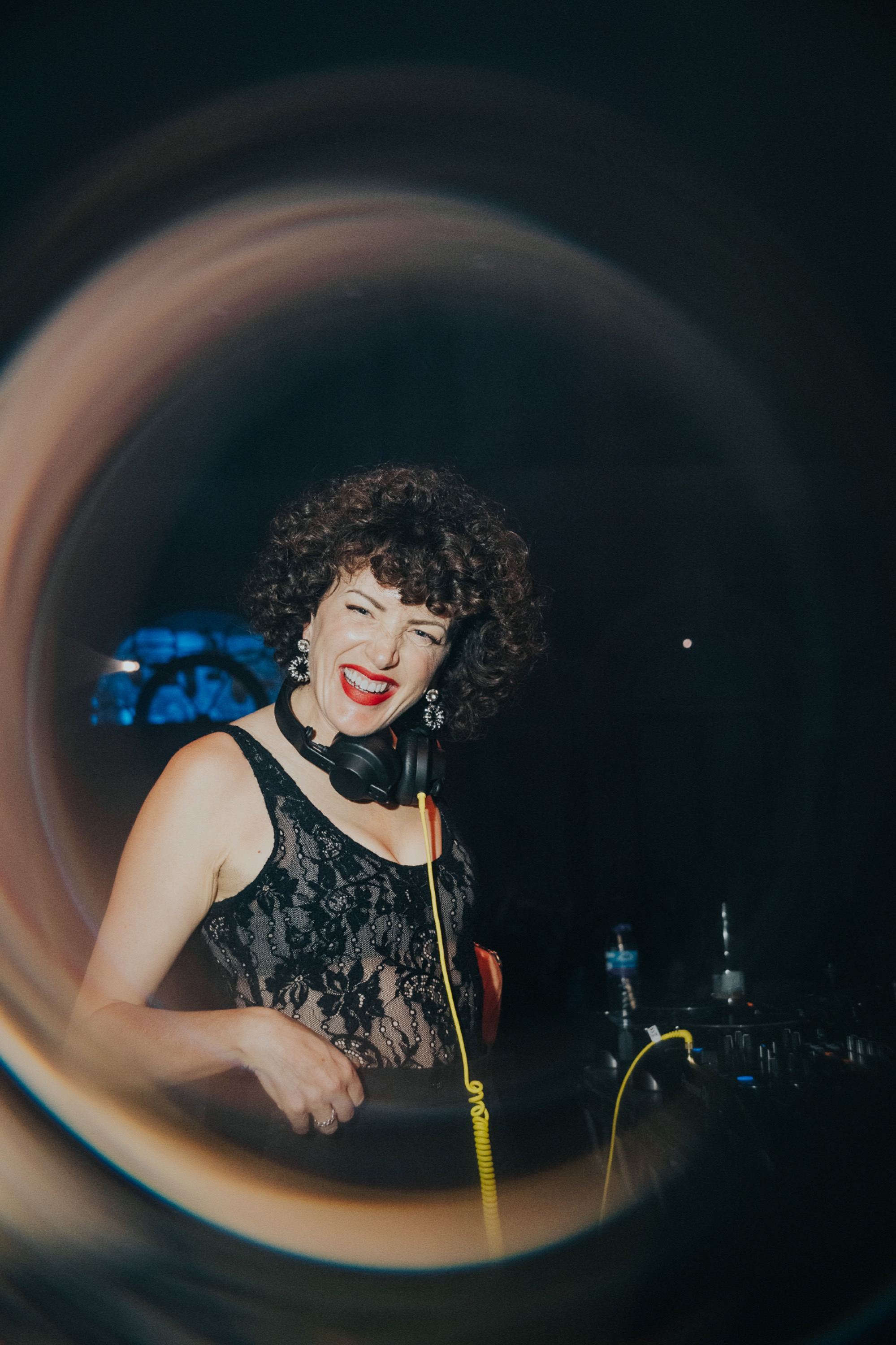 Annie laughing behind the decks