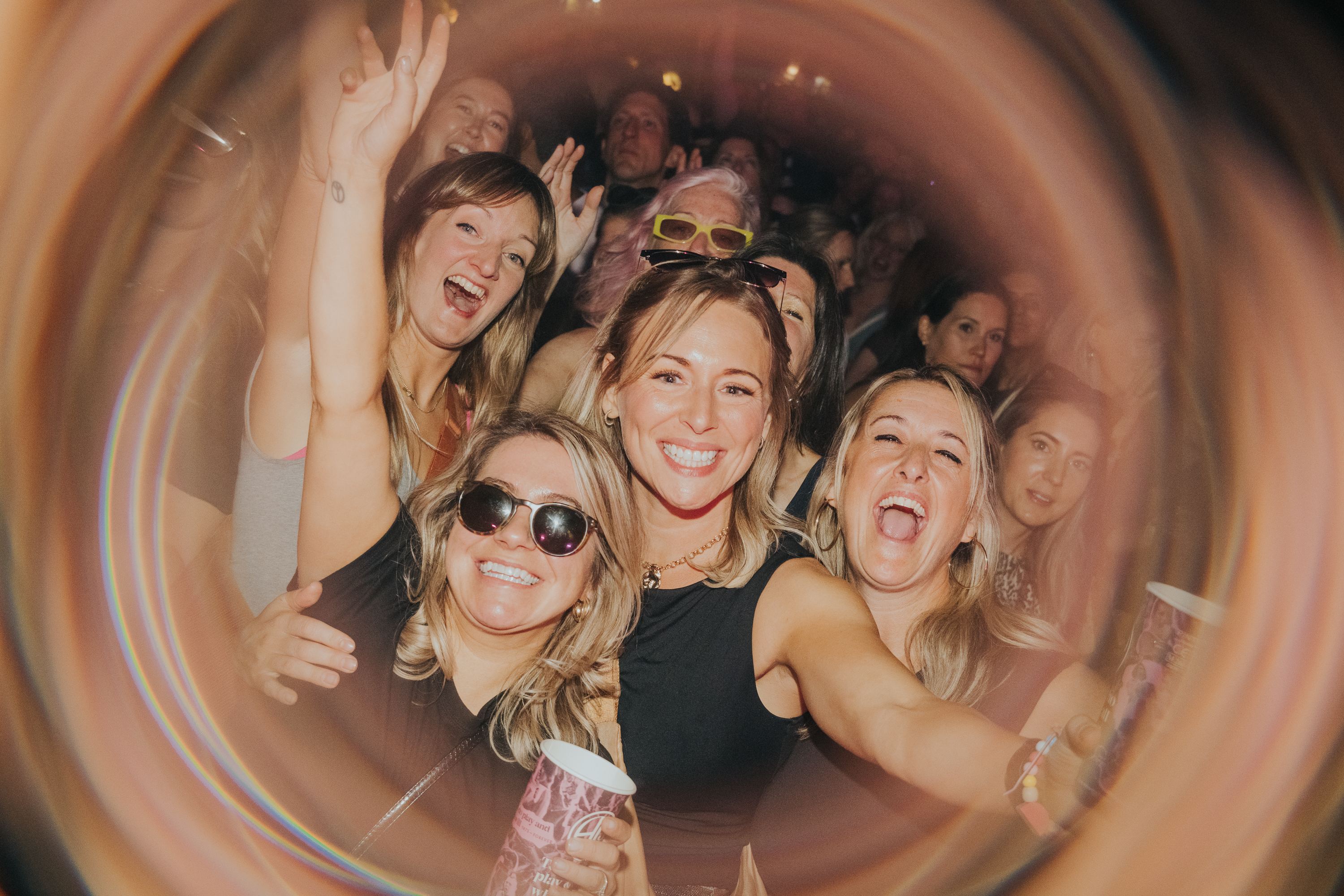 A group of friends mid-dance, grinning at the camera